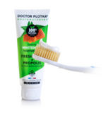 tube of Dr plotka's whitening toothpaste with a toothbrush in front 